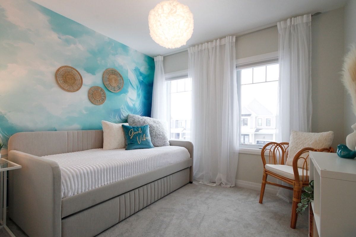 The Air Room: a light daybed with a trundle under a sky-blue mural
